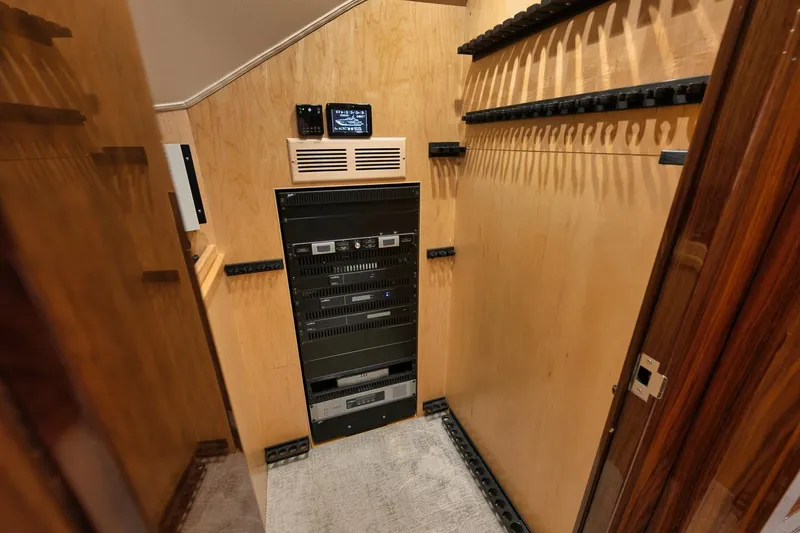  Yacht Photos Pics 2019 Viking 80 Convertible yacht interior with electronic equipment and wooden paneling.