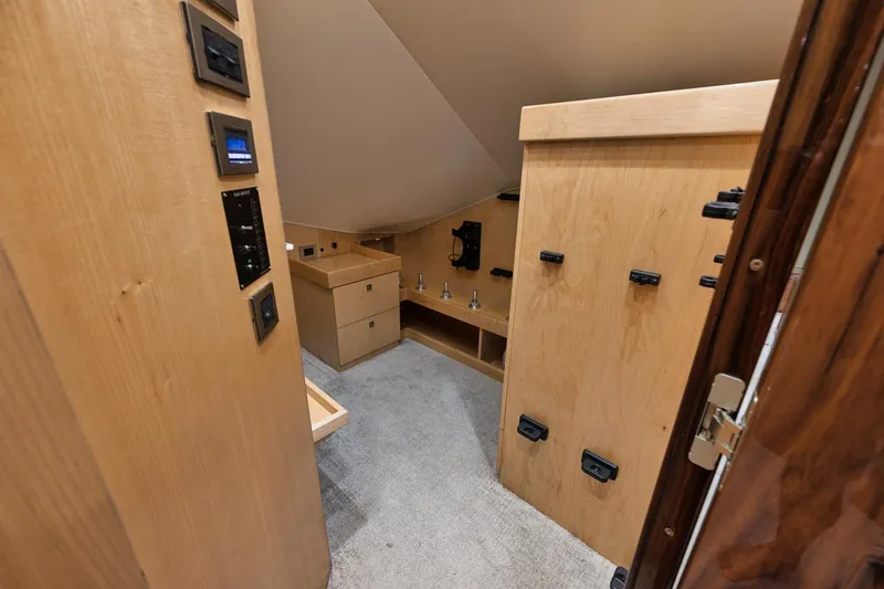  Yacht Photos Pics Interior of 2019 Viking 80 Convertible yacht, featuring wood cabinetry and modern controls.