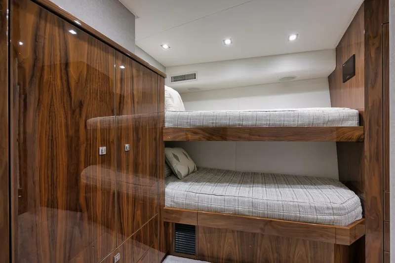  Yacht Photos Pics Luxurious 2019 Viking 80 Convertible yacht cabin with wooden bunk beds and modern lighting.