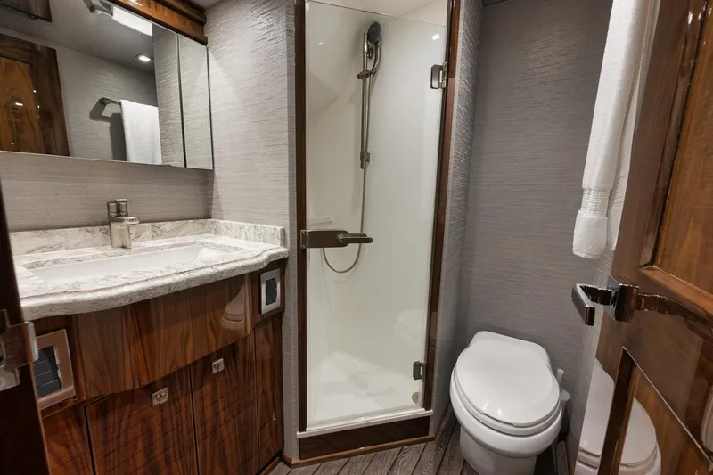  Yacht Photos Pics Luxurious bathroom in 2019 Viking 80 Convertible yacht with shower, toilet, and vanity.