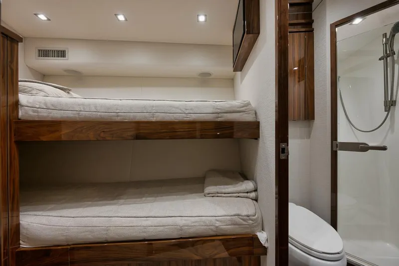  Yacht Photos Pics Interior of 2019 Viking 80 Convertible yacht with bunk beds and bathroom.