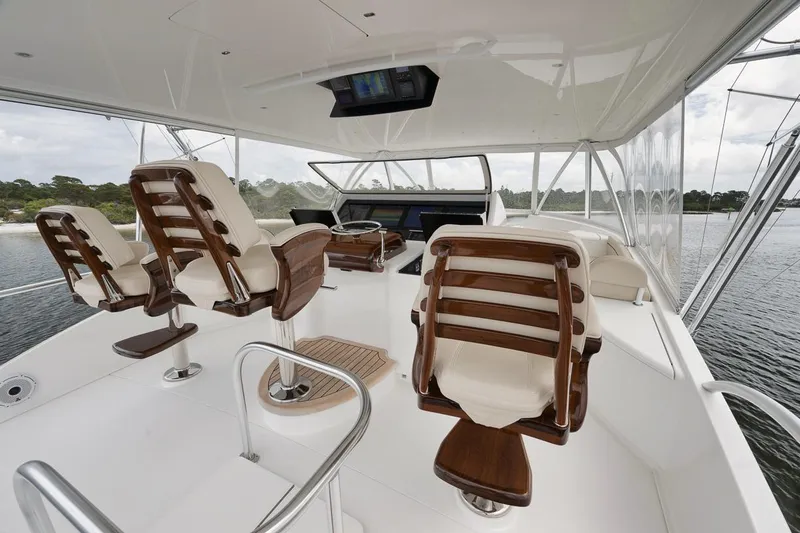  Yacht Photos Pics 2019 Viking 80 Convertible yacht helm with luxurious seating and panoramic views.
