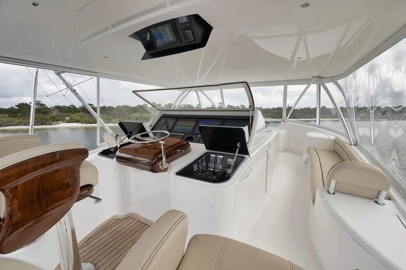  Yacht Photos Pics Luxurious interior of 2019 Viking 80 Convertible yacht with modern helm and seating.
