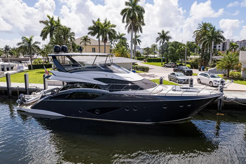 No Name 66 Marquis Yacht Photos Pics 2017 Marquis 660 Sport Yacht docked near palm trees and parked cars.