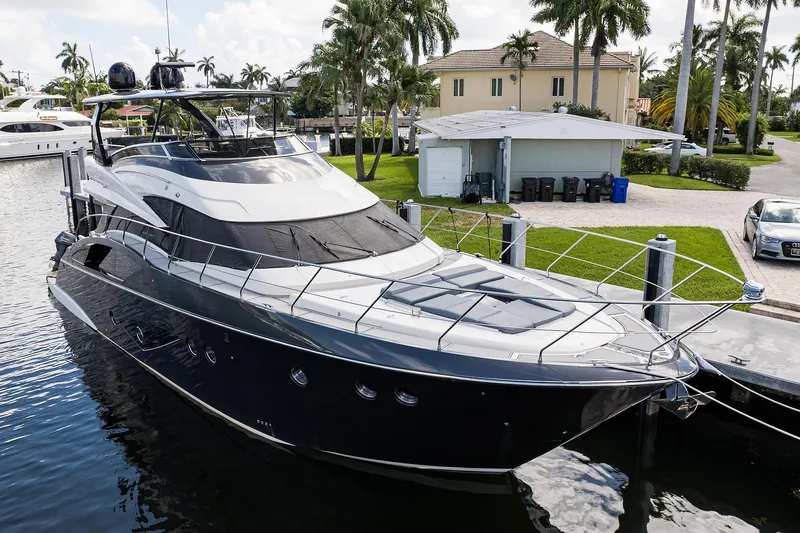 No Name 66 Marquis Yacht Photos Pics 2017 Marquis 660 Sport Yacht docked near palm trees and waterfront property.