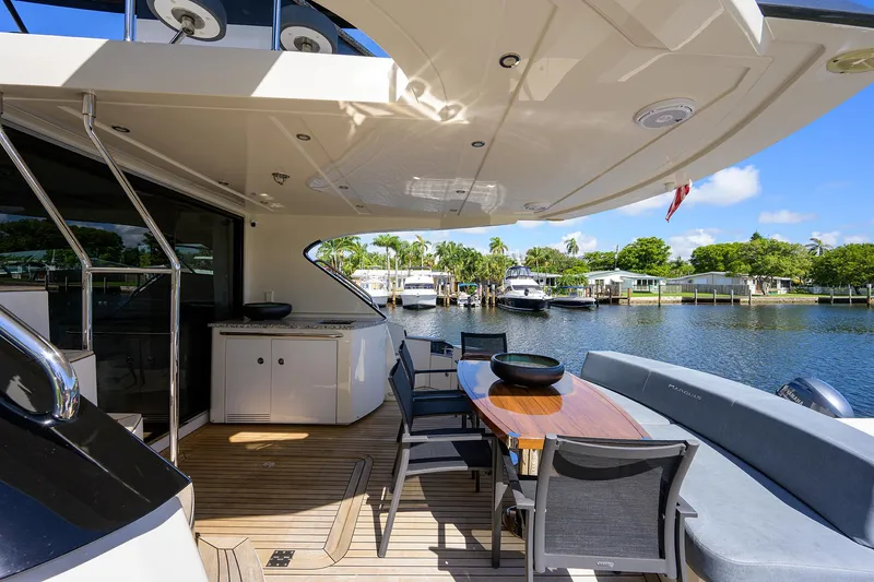 No Name 66 Marquis Yacht Photos Pics 2017 Marquis 660 Sport Yacht deck with seating, table, and waterfront view.
