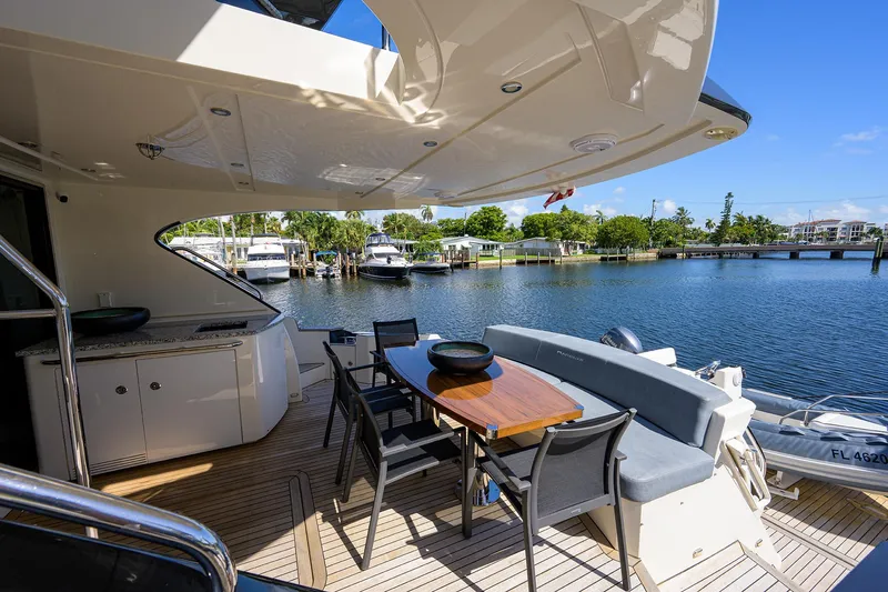 No Name 66 Marquis Yacht Photos Pics 2017 Marquis 660 Sport Yacht deck with dining area overlooking marina.