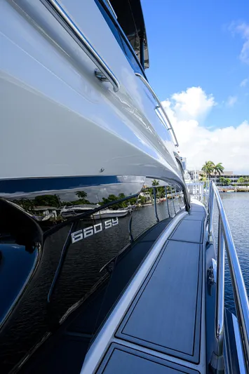 No Name 66 Marquis Yacht Photos Pics 2017 Marquis 660 Sport Yacht, sleek design, docked by the water under a clear blue sky.