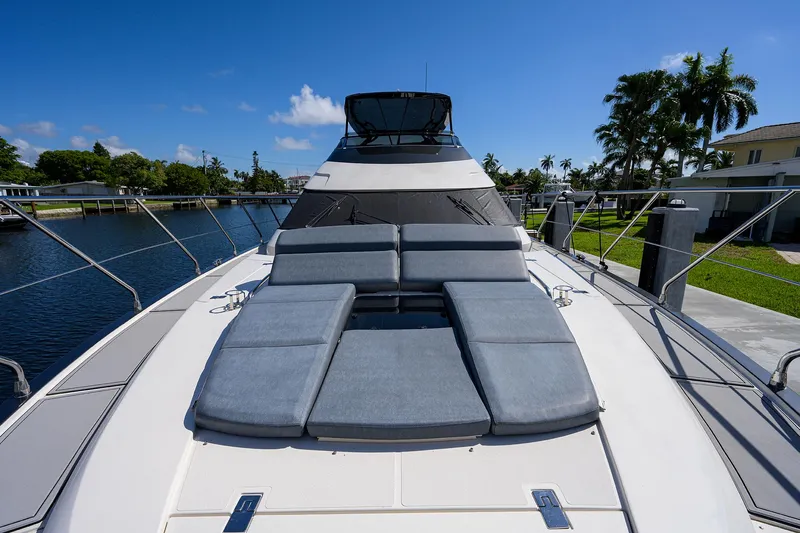 No Name 66 Marquis Yacht Photos Pics 2017 Marquis 660 Sport Yacht with sun loungers on deck, docked by a canal.