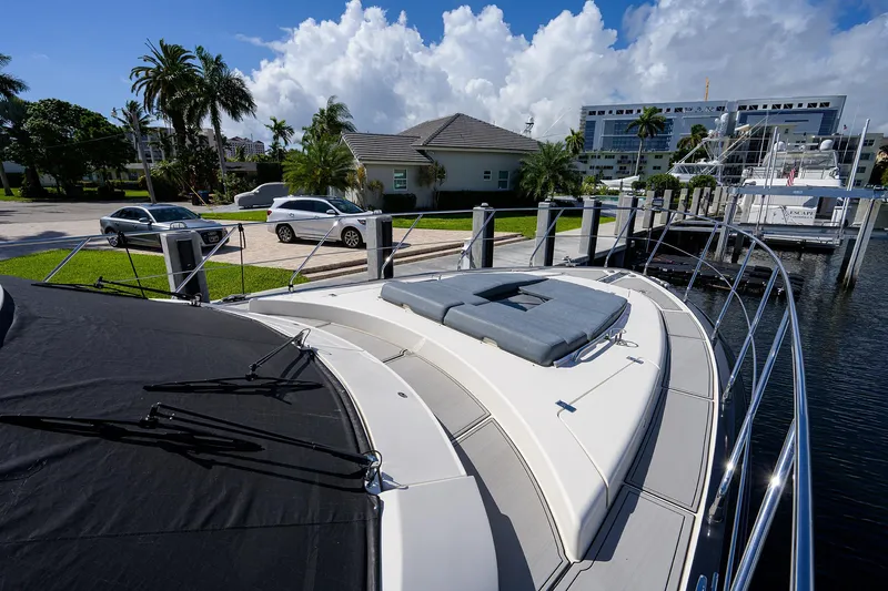 No Name 66 Marquis Yacht Photos Pics 2017 Marquis 660 Sport Yacht docked near waterfront homes and palm trees.