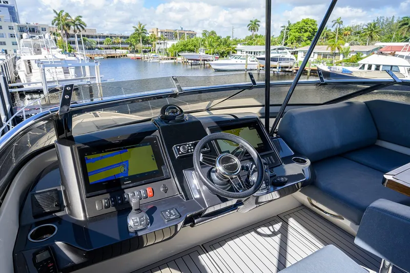 No Name 66 Marquis Yacht Photos Pics Cockpit of 2017 Marquis 660 Sport Yacht with modern navigation equipment and waterfront view.