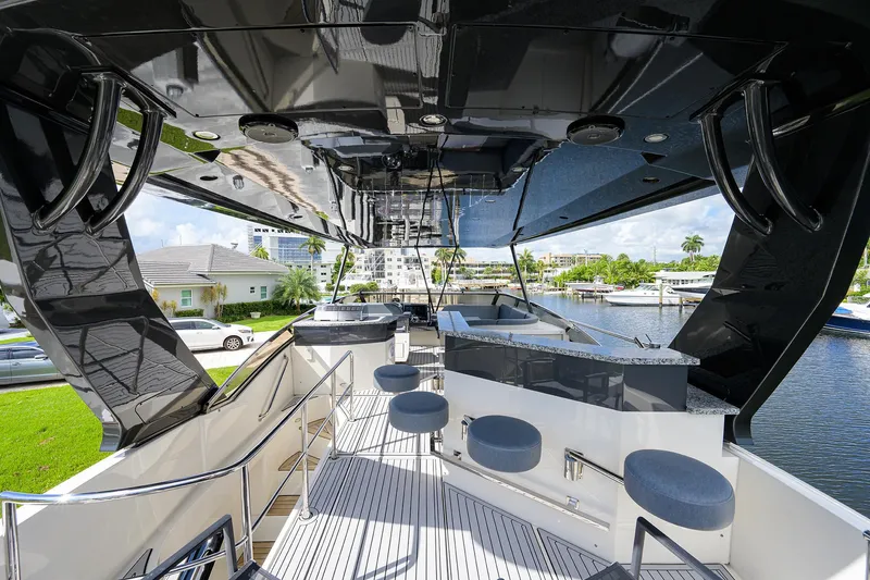 No Name 66 Marquis Yacht Photos Pics 2017 Marquis 660 Sport Yacht deck with bar stools and waterfront view.