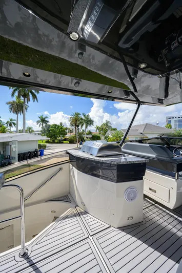 No Name 66 Marquis Yacht Photos Pics 2017 Marquis 660 Sport Yacht deck with outdoor kitchen and tropical view.