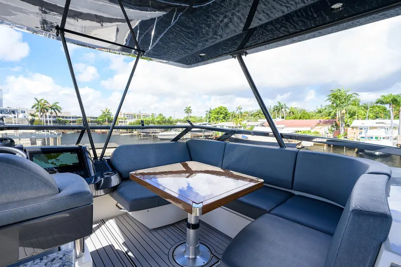 No Name 66 Marquis Yacht Photos Pics 2017 Marquis 660 Sport Yacht interior with luxurious seating and table, overlooking marina.