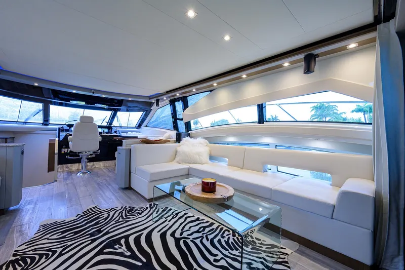 No Name 66 Marquis Yacht Photos Pics Luxurious interior of 2017 Marquis 660 Sport Yacht with modern seating and zebra-patterned rug.
