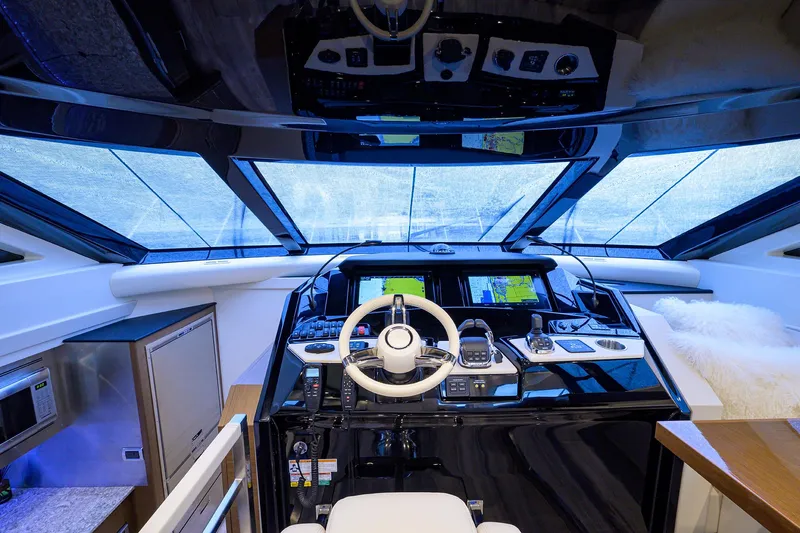 No Name 66 Marquis Yacht Photos Pics 2017 Marquis 660 Sport Yacht helm with modern navigation equipment and panoramic windows.