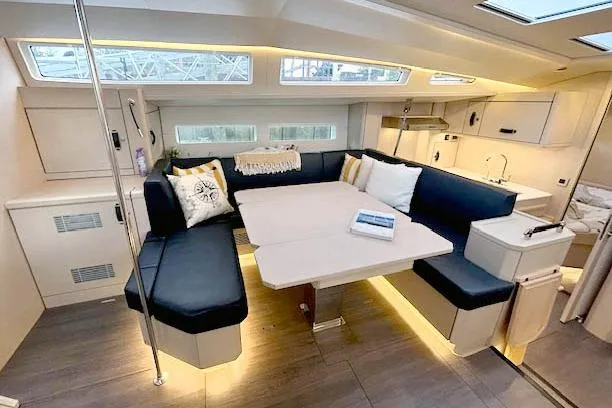 Chase'n Grace Yacht Photos Pics Luxurious interior of 2022 Jeanneau Yachts 60 with modern seating and dining area.