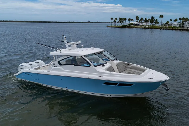  Yacht Photos Pics 2023 Pursuit DC 365 Dual Console boat on calm water, featuring sleek design and modern amenities.