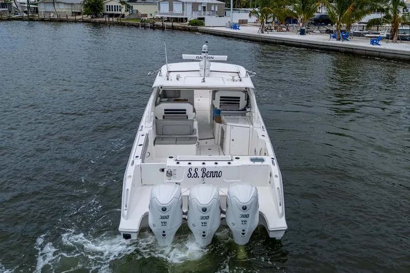  Yacht Photos Pics 2023 Pursuit DC 365 Dual Console boat with triple engines on water.