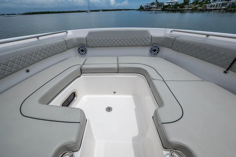  Yacht Photos Pics 2023 Pursuit DC 365 Dual Console boat interior with cushioned seating and scenic water view.