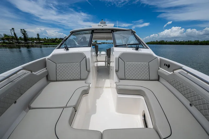  Yacht Photos Pics 2023 Pursuit DC 365 Dual Console boat interior with luxurious seating and scenic water view.