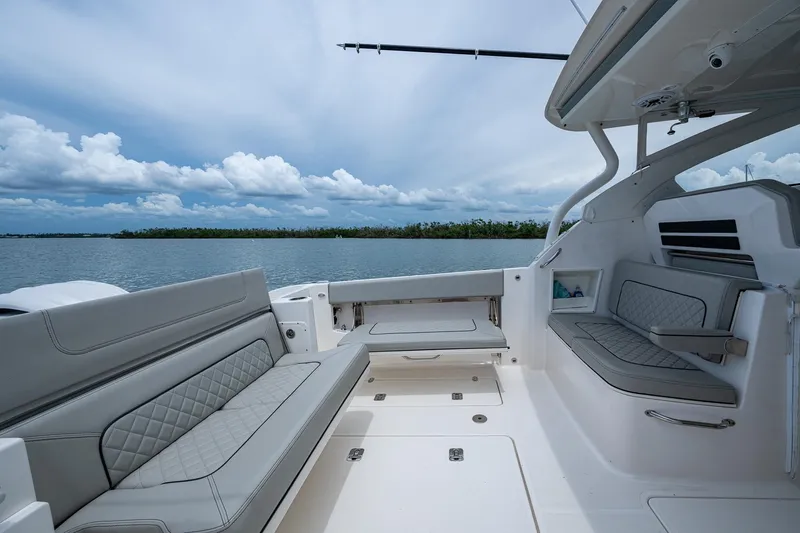  Yacht Photos Pics 2023 Pursuit DC 365 Dual Console boat interior with gray seating, open water view.