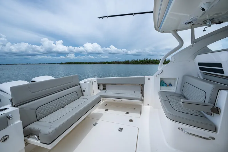  Yacht Photos Pics 2023 Pursuit DC 365 Dual Console boat interior with luxurious seating and scenic water view.