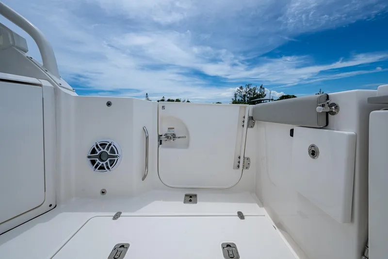  Yacht Photos Pics 2023 Pursuit DC 365 Dual Console boat interior with speaker, hatch, and clear sky.