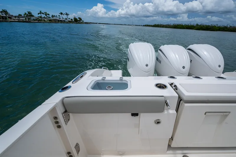  Yacht Photos Pics 2023 Pursuit DC 365 Dual Console boat with triple engines on a scenic waterway.