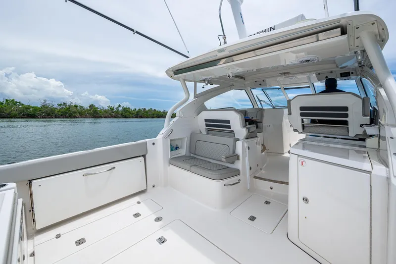  Yacht Photos Pics 2023 Pursuit DC 365 Dual Console boat interior with seating and water view.