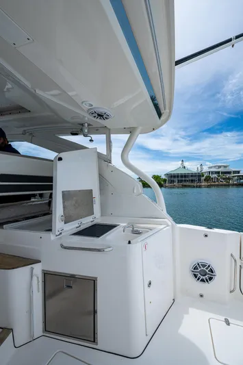  Yacht Photos Pics 2023 Pursuit DC 365 Dual Console boat interior with open storage, dockside view.