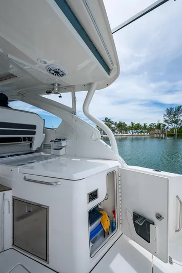  Yacht Photos Pics 2023 Pursuit DC 365 Dual Console boat interior with storage and scenic water view.