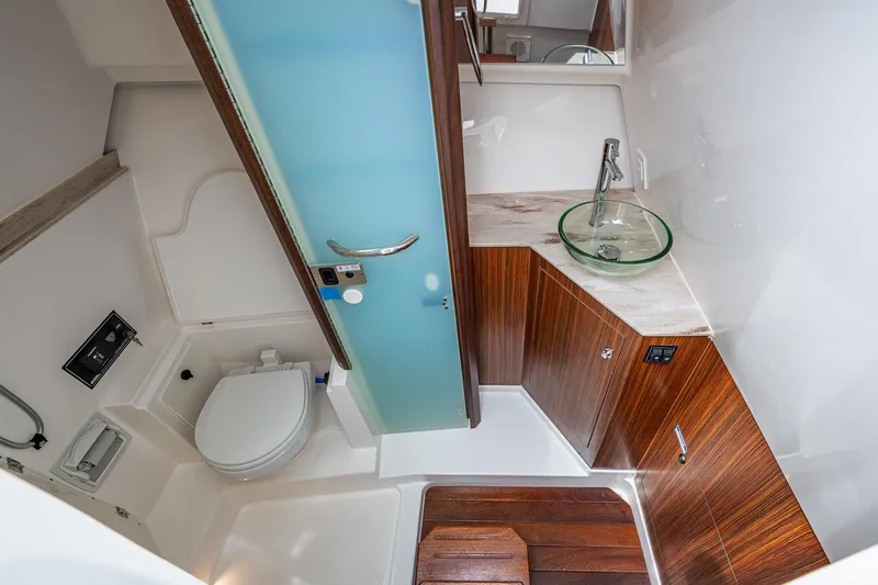  Yacht Photos Pics Luxurious bathroom in 2023 Pursuit DC 365 Dual Console boat with modern fixtures.
