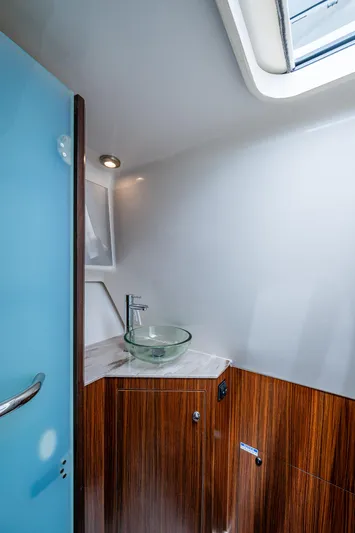  Yacht Photos Pics 2023 Pursuit DC 365 Dual Console boat interior with modern sink and wood finish.