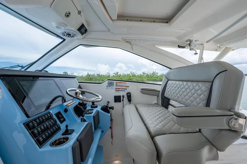  Yacht Photos Pics 2023 Pursuit DC 365 Dual Console interior with modern helm and luxurious seating.