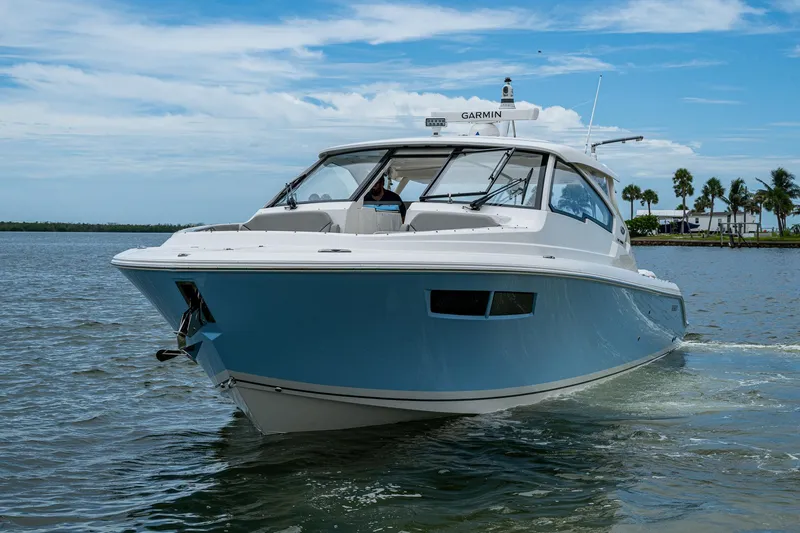  Yacht Photos Pics 2023 Pursuit DC 365 Dual Console boat cruising on a sunny day.