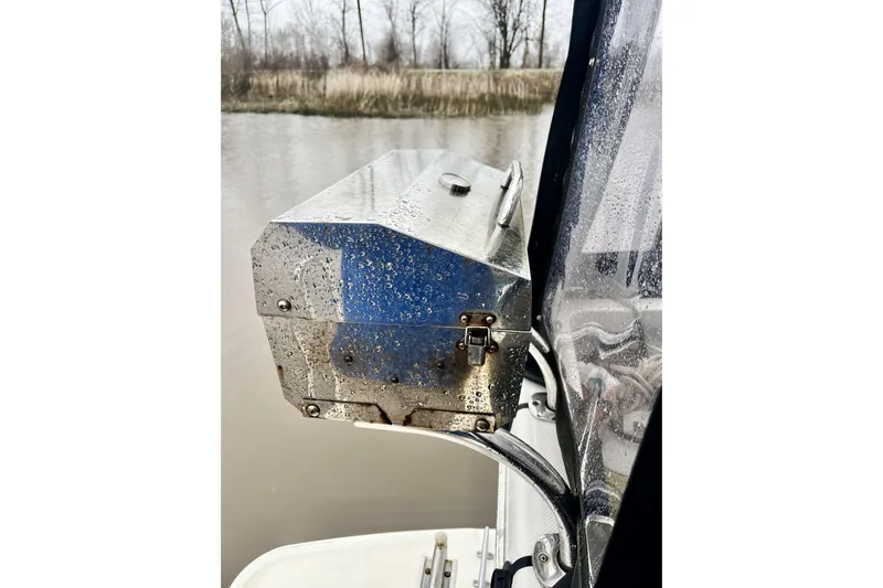  Yacht Photos Pics Rain-soaked metal box on 1996 Bayliner 3988 Motoryacht, near a calm riverbank.