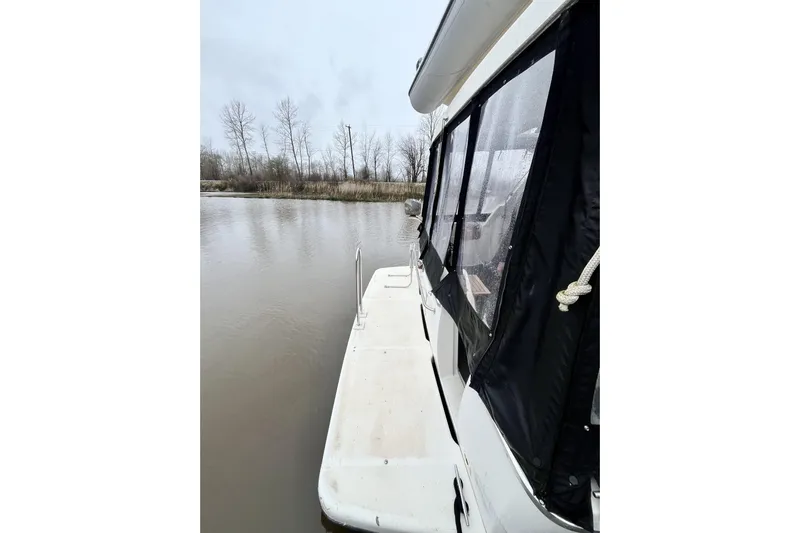  Yacht Photos Pics 1996 Bayliner 3988 Motoryacht docked on a calm river, overcast sky.