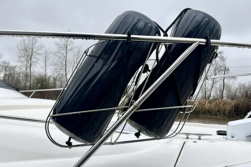  Yacht Photos Pics 1996 Bayliner 3988 Motoryacht with black fenders on deck, overcast sky.