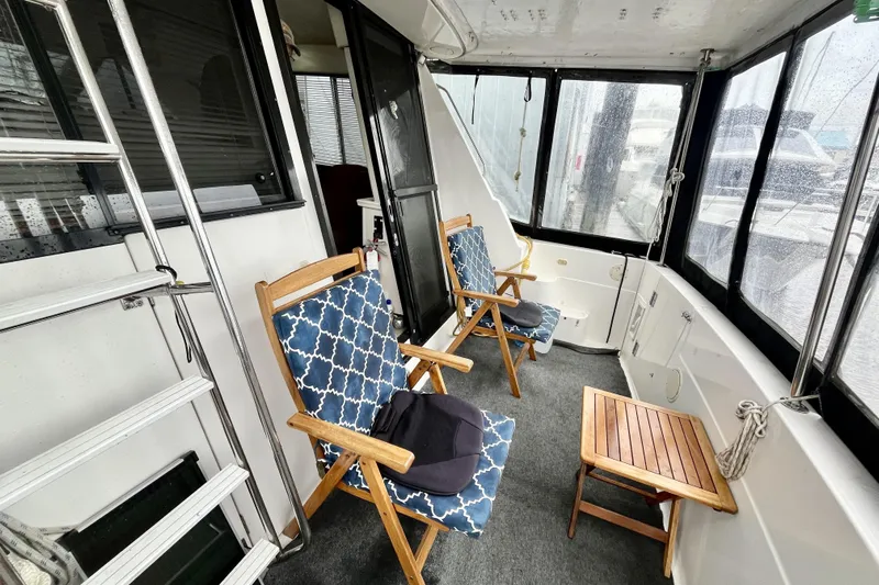  Yacht Photos Pics 1996 Bayliner 3988 Motoryacht interior with chairs and table on deck.