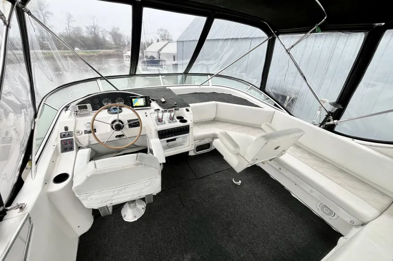  Yacht Photos Pics 1996 Bayliner 3988 Motoryacht helm with steering wheel, controls, and seating area.