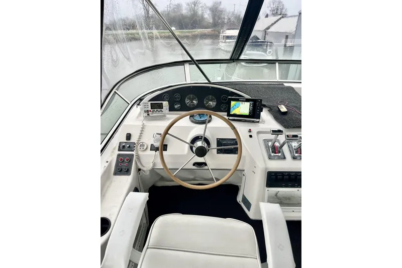  Yacht Photos Pics 1996 Bayliner 3988 Motoryacht helm with steering wheel, controls, and navigation equipment.