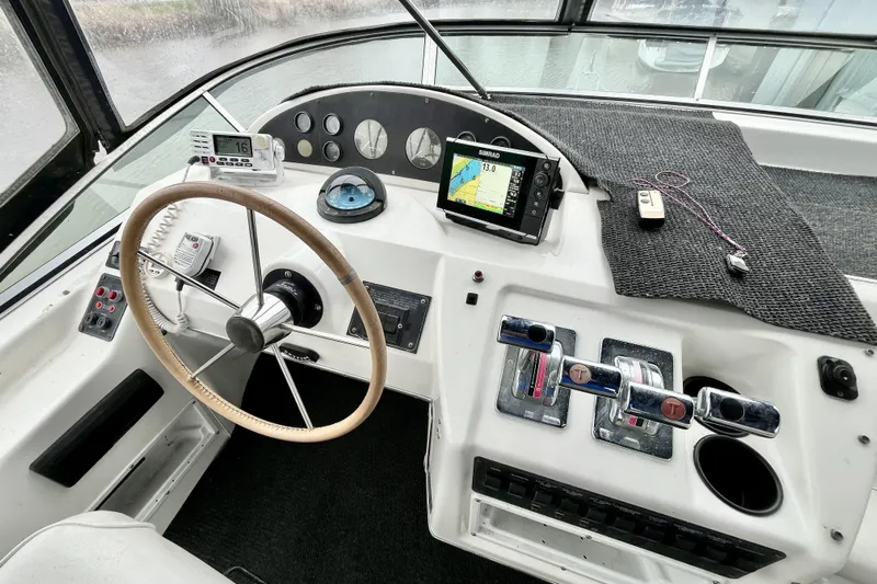 Yacht Photos Pics Helm of 1996 Bayliner 3988 Motoryacht with steering wheel, navigation equipment, and controls.