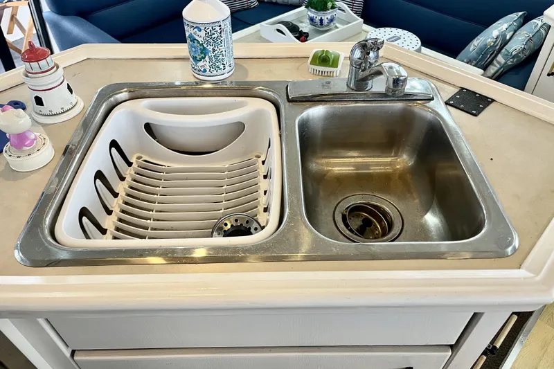  Yacht Photos Pics Kitchen sink area on a 1996 Bayliner 3988 Motoryacht with dish rack and faucet.
