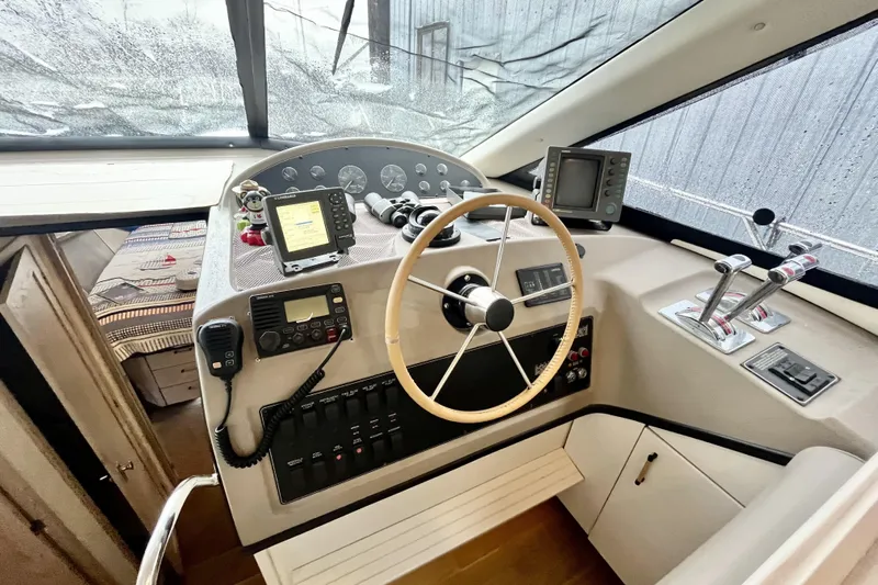 Yacht Photos Pics 1996 Bayliner 3988 Motoryacht helm with steering wheel, navigation instruments, and controls.