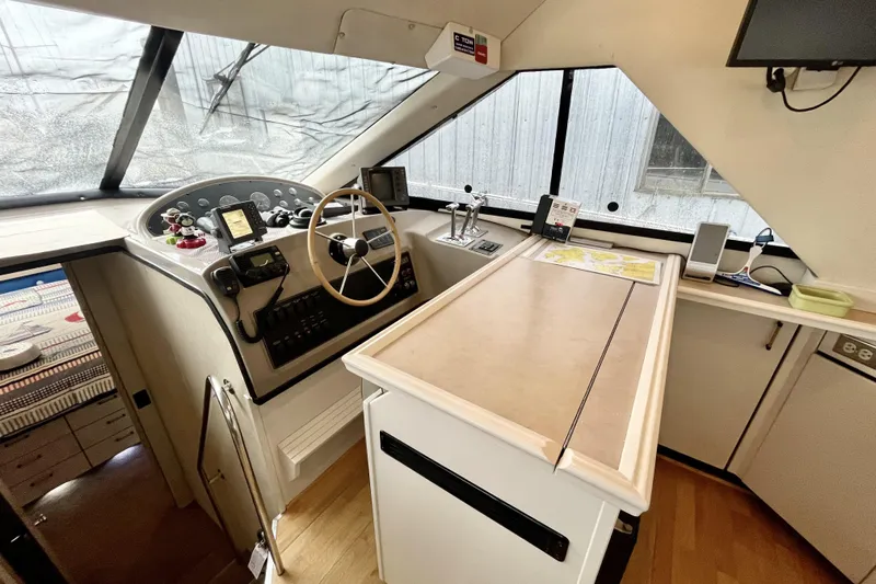  Yacht Photos Pics 1996 Bayliner 3988 Motoryacht helm with steering wheel, navigation instruments, and control panel.