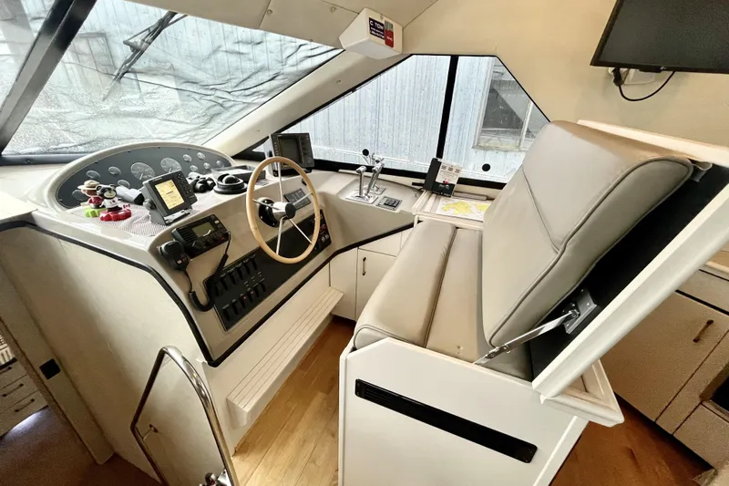  Yacht Photos Pics Interior helm of 1996 Bayliner 3988 Motoryacht with steering wheel and navigation controls.