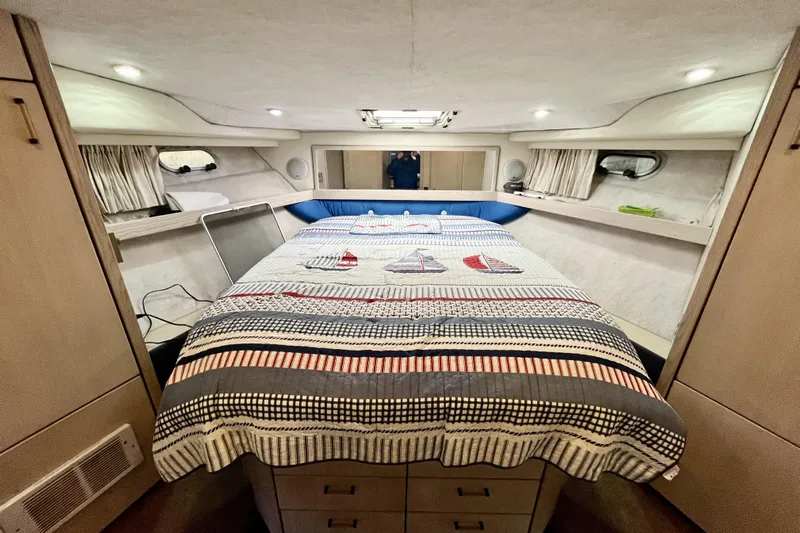  Yacht Photos Pics Interior cabin of 1996 Bayliner 3988 Motoryacht with bed and storage cabinets.