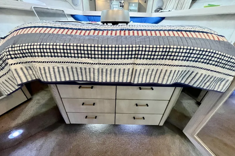  Yacht Photos Pics Interior of 1996 Bayliner 3988 Motoryacht with striped bedding and storage drawers.