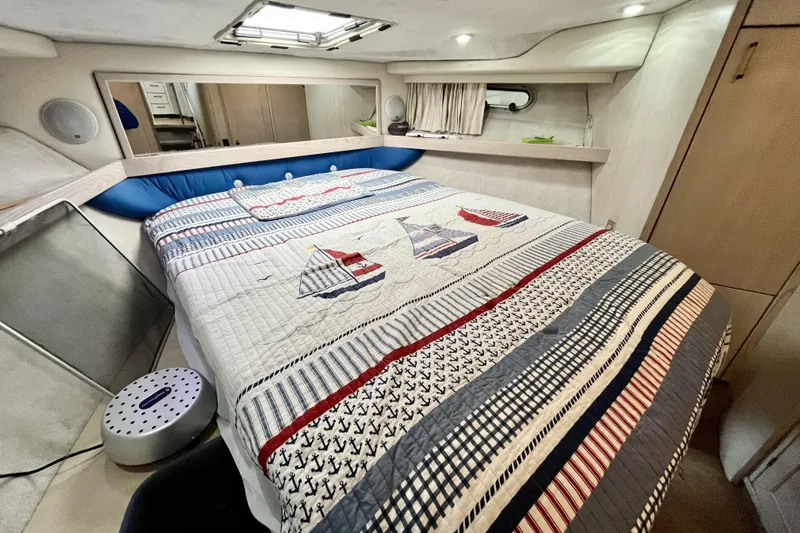  Yacht Photos Pics Cozy bedroom in 1996 Bayliner 3988 Motoryacht with nautical-themed bedding.